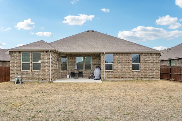 back of property featuring a yard and a patio area