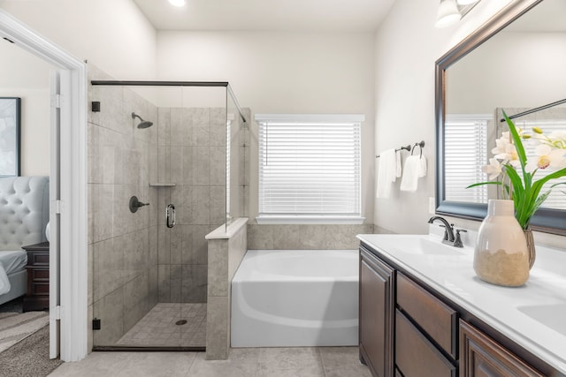 bathroom with independent shower and bath, vanity, and tile patterned floors