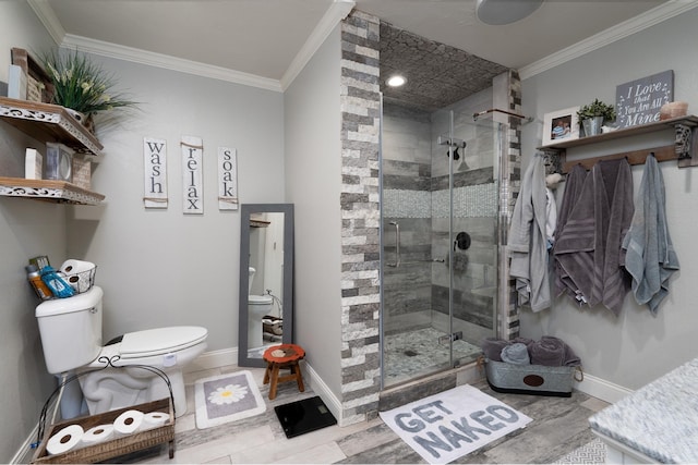 bathroom featuring ornamental molding, toilet, and a shower with shower door