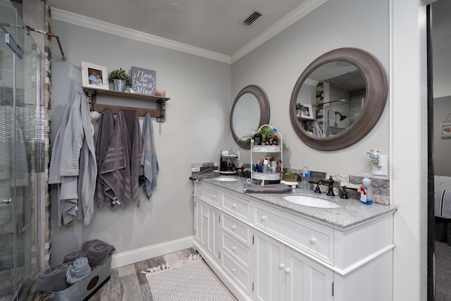 bathroom with vanity, hardwood / wood-style flooring, a shower with door, and ornamental molding