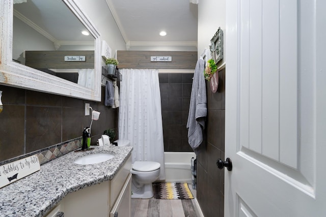 full bathroom featuring hardwood / wood-style floors, ornamental molding, shower / bath combo, and vanity