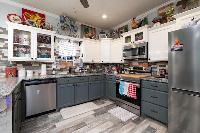 kitchen featuring sink, white cabinetry, crown molding, gray cabinets, and stainless steel appliances