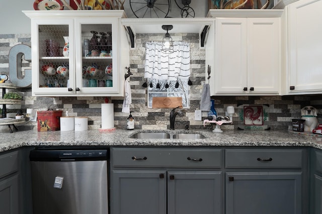 kitchen featuring gray cabinetry, stainless steel dishwasher, and white cabinets