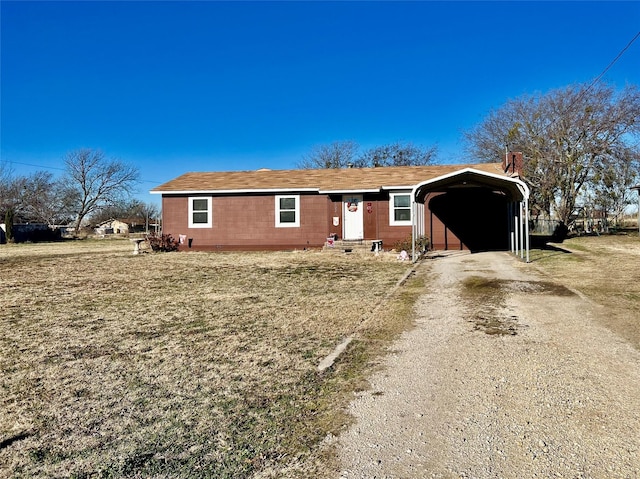 single story home featuring a carport and a front yard