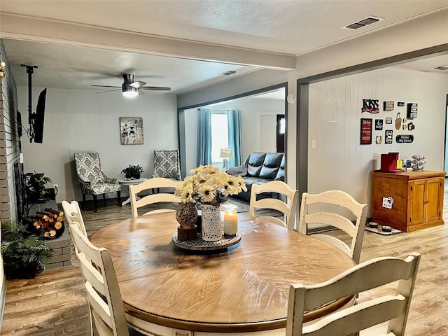 dining area featuring ceiling fan and light wood-type flooring