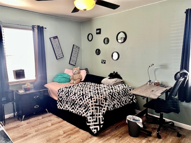 bedroom with hardwood / wood-style flooring and ceiling fan