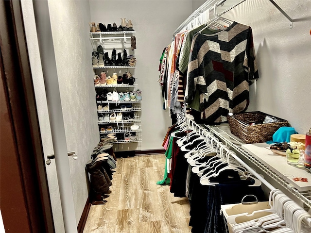 spacious closet featuring light hardwood / wood-style floors