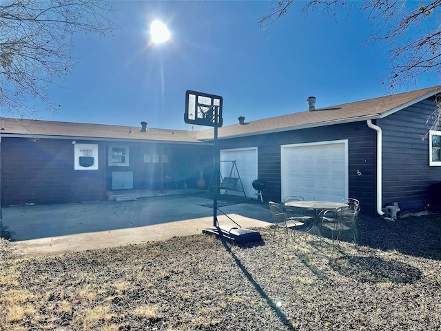 rear view of property featuring a garage