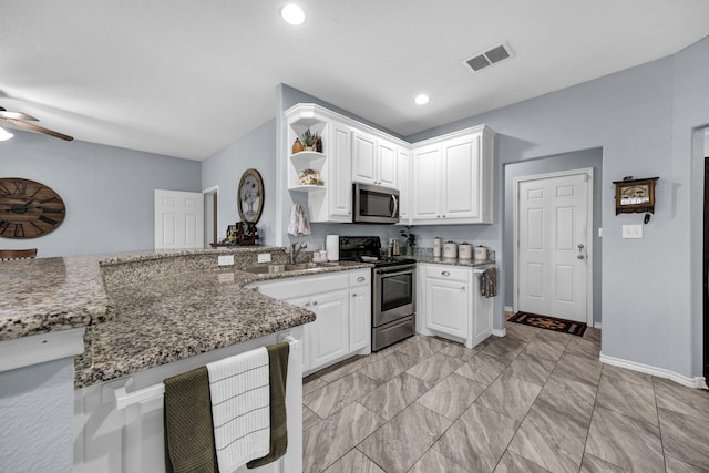 kitchen featuring white cabinetry, kitchen peninsula, and appliances with stainless steel finishes