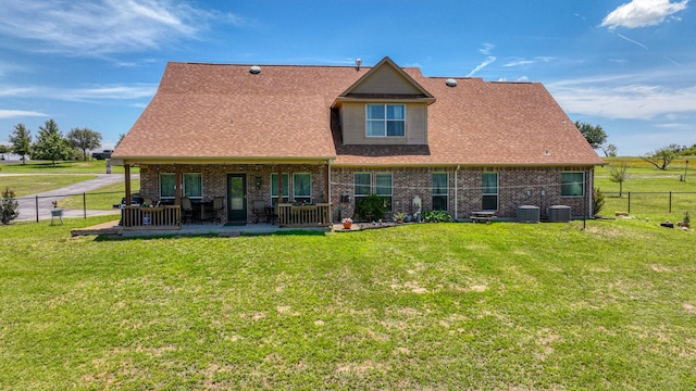 back of property featuring a patio, central AC unit, and a lawn