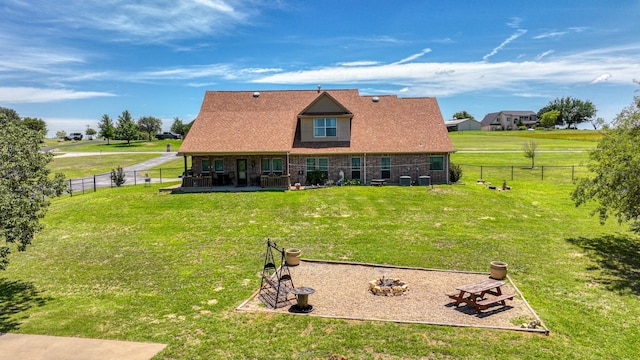 rear view of house with a yard