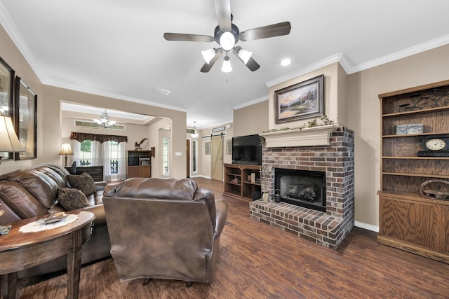 living room featuring a brick fireplace, ornamental molding, dark hardwood / wood-style floors, ceiling fan, and a barn door