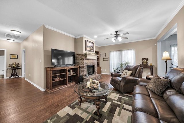 living room featuring wood-type flooring, ceiling fan, a fireplace, and crown molding