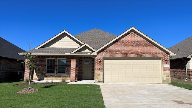 view of front of home with a garage and a front yard