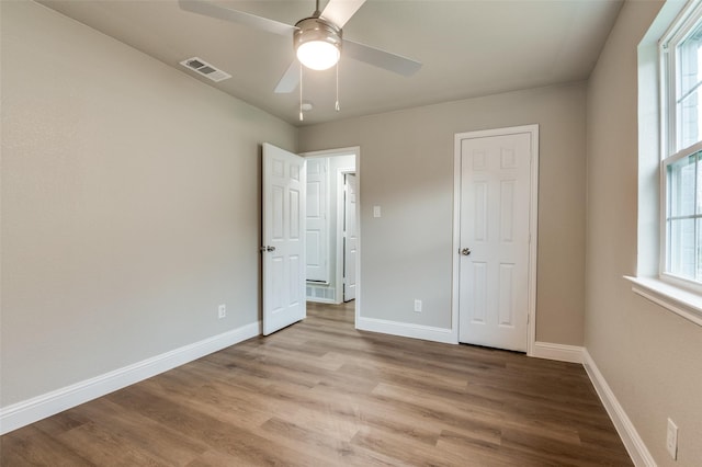 unfurnished bedroom with ceiling fan and light hardwood / wood-style floors