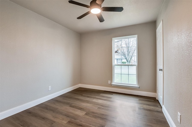 unfurnished room with dark wood-type flooring and ceiling fan