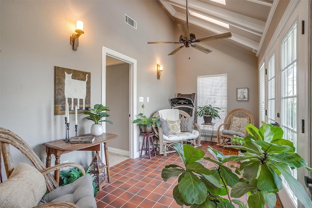 interior space featuring ceiling fan, high vaulted ceiling, tile patterned floors, and beam ceiling