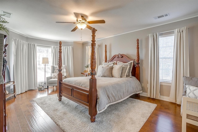 bedroom with crown molding, hardwood / wood-style flooring, and ceiling fan