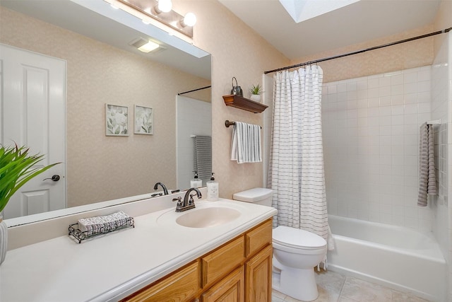 full bathroom featuring tile patterned flooring, a skylight, vanity, shower / bath combination with curtain, and toilet