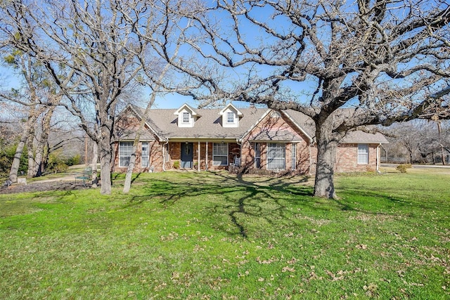 cape cod house with a front yard