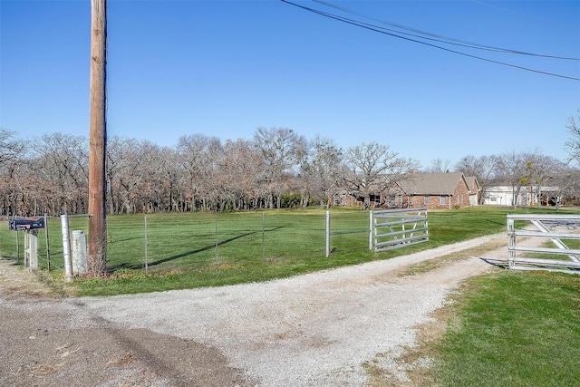 view of community with a yard and a rural view