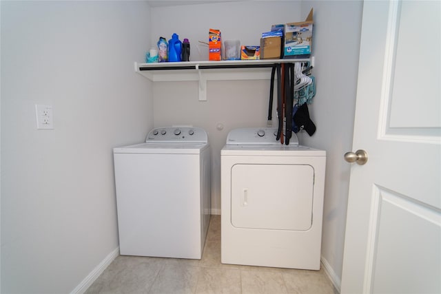 laundry room featuring separate washer and dryer and light tile patterned floors