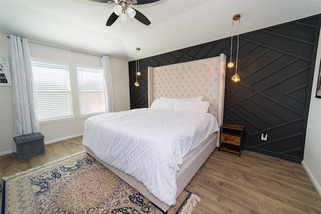 bedroom with lofted ceiling, wood-type flooring, and ceiling fan