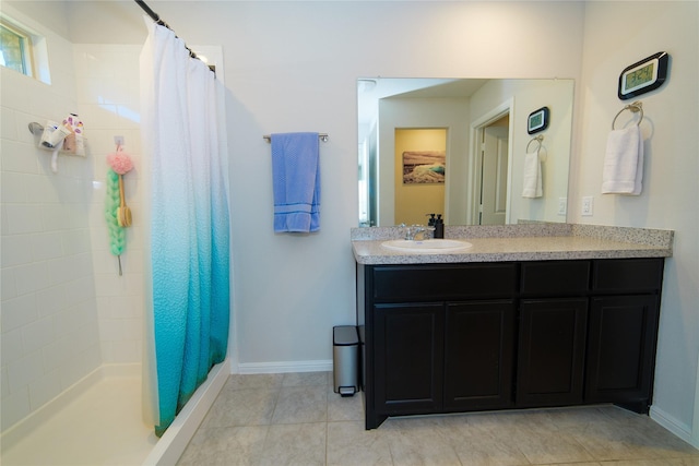 bathroom featuring tile patterned flooring, vanity, and curtained shower