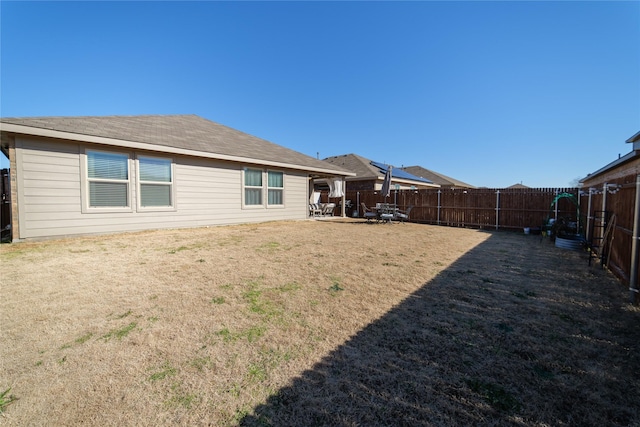 rear view of house featuring a patio and a lawn