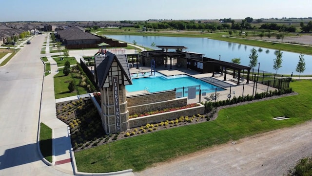 view of pool featuring a water view and a patio