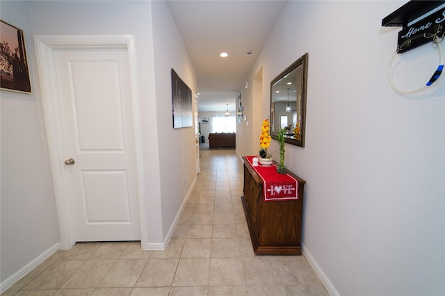 hall featuring light tile patterned flooring