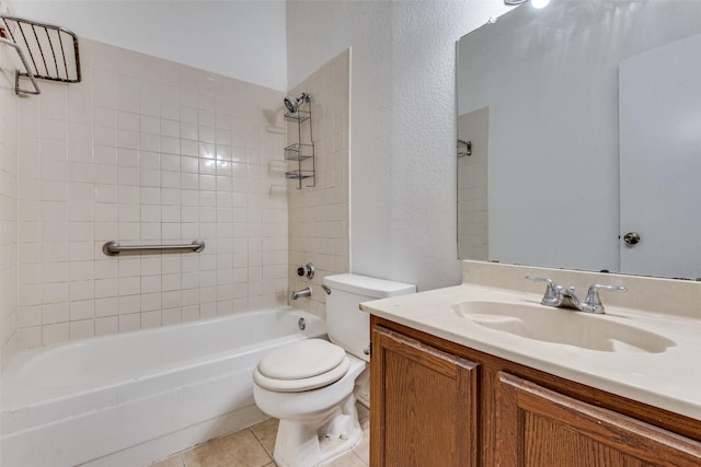 full bathroom featuring tiled shower / bath combo, vanity, tile patterned floors, and toilet