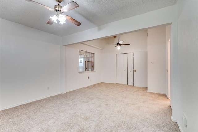 carpeted empty room with a textured ceiling and ceiling fan