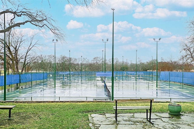 view of sport court featuring a lawn and fence