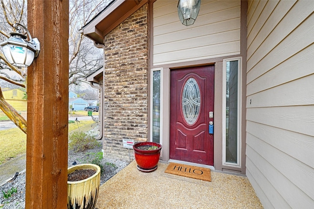 entrance to property with brick siding