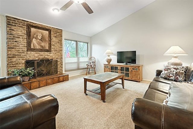 living room with lofted ceiling, a brick fireplace, ceiling fan, and light colored carpet