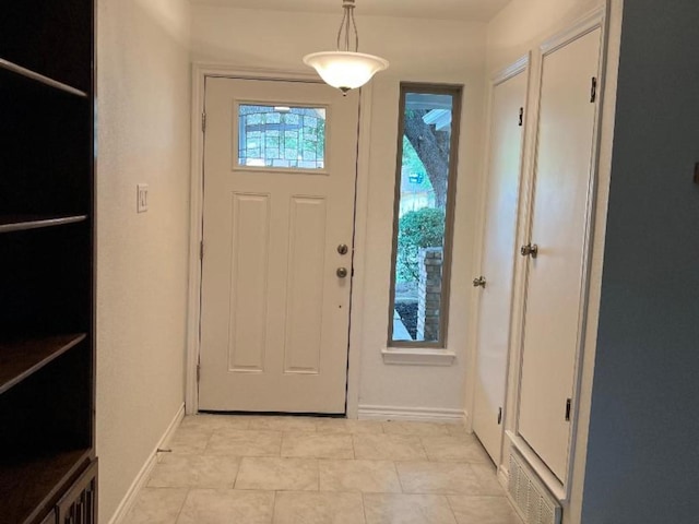 doorway to outside featuring light tile patterned floors