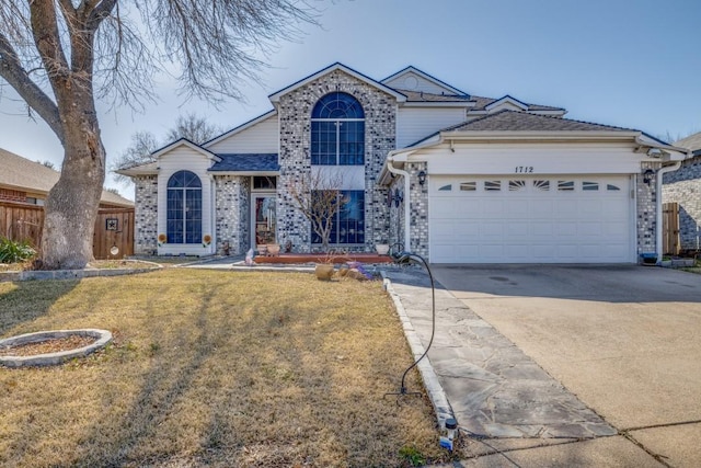 view of front of property featuring a garage and a front yard