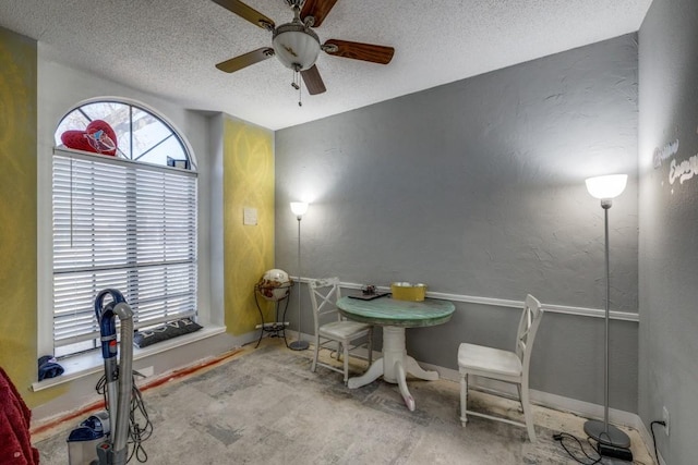 interior space featuring ceiling fan and a textured ceiling