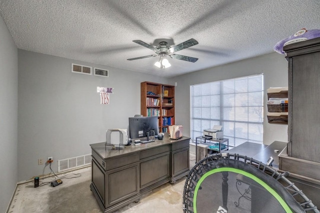 office area featuring a textured ceiling and ceiling fan