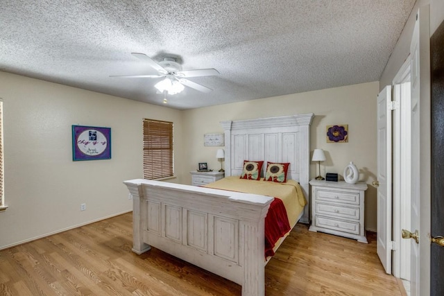 bedroom featuring ceiling fan, light hardwood / wood-style floors, and a textured ceiling