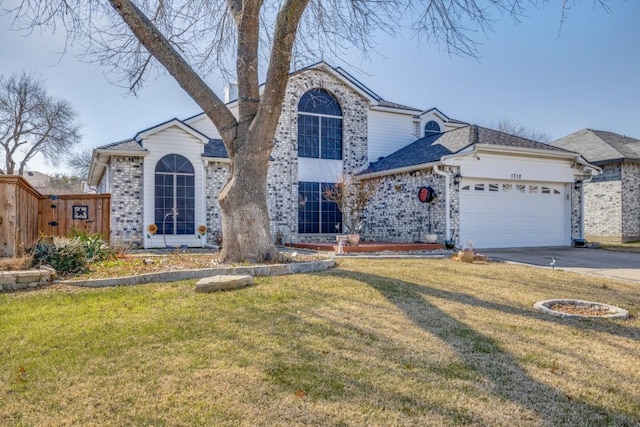 view of front of property featuring a garage and a front lawn