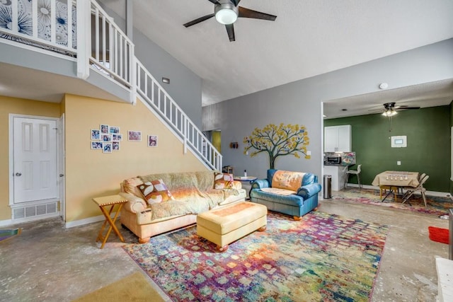 living room with concrete flooring and ceiling fan