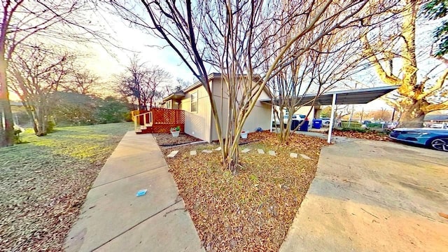 view of property exterior with a carport