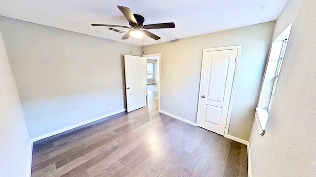 unfurnished bedroom with wood-type flooring and ceiling fan