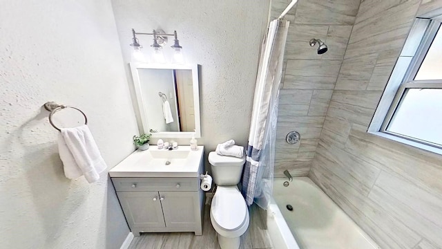 full bathroom featuring vanity, wood-type flooring, shower / bathtub combination with curtain, and toilet