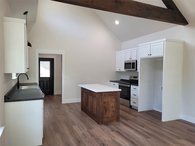 kitchen featuring dark wood-type flooring, sink, white cabinetry, a center island, and appliances with stainless steel finishes