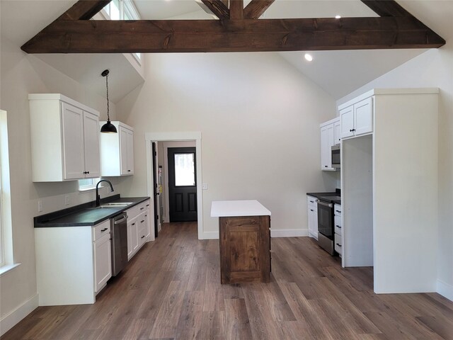 kitchen featuring white cabinetry, hanging light fixtures, stainless steel appliances, and sink