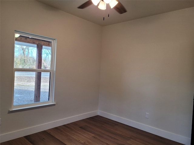 spare room featuring dark wood-type flooring and ceiling fan