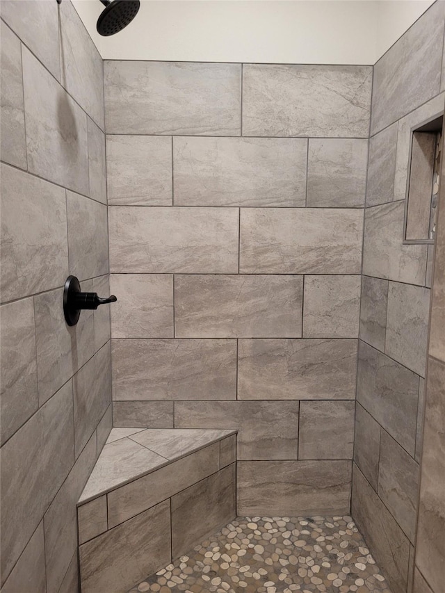 bathroom with tiled shower